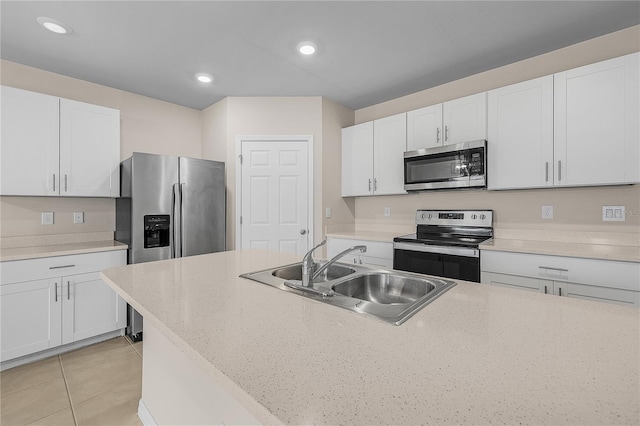 kitchen featuring appliances with stainless steel finishes, recessed lighting, white cabinets, and a sink