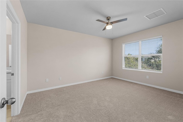 empty room featuring ceiling fan, visible vents, baseboards, and light colored carpet