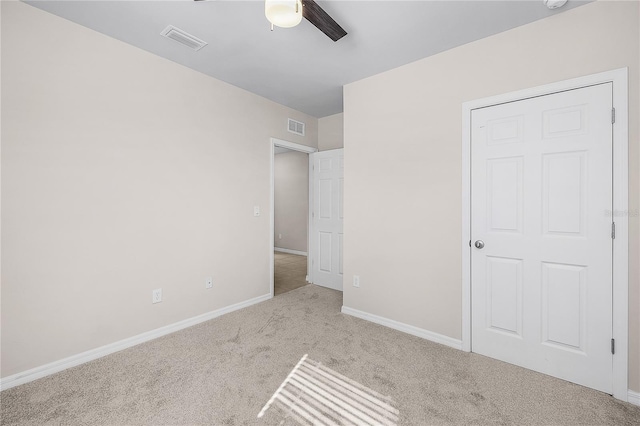 unfurnished bedroom with a ceiling fan, baseboards, visible vents, and carpet flooring