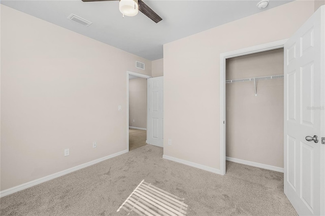 unfurnished bedroom with carpet, a closet, visible vents, and baseboards