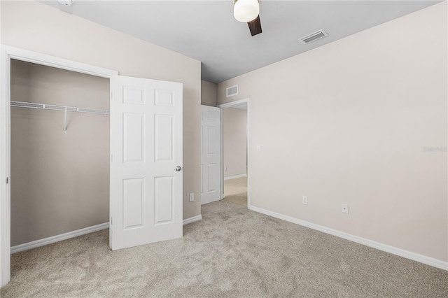 unfurnished bedroom with baseboards, a closet, visible vents, and carpet flooring