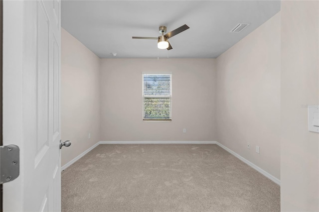 spare room featuring visible vents, baseboards, ceiling fan, and carpet flooring