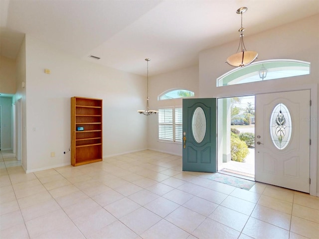 entrance foyer featuring visible vents, a notable chandelier, baseboards, and light tile patterned floors