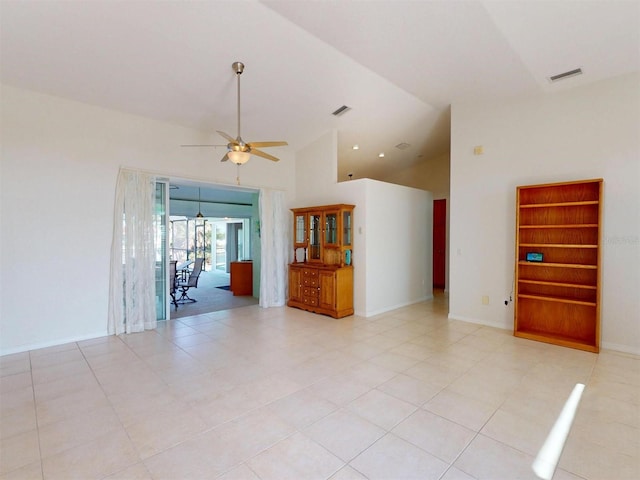 spare room featuring ceiling fan, high vaulted ceiling, visible vents, and baseboards