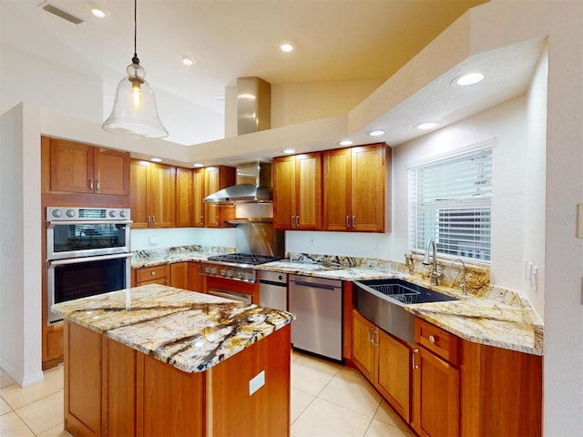 kitchen with stainless steel appliances, visible vents, a sink, wall chimney range hood, and light stone countertops