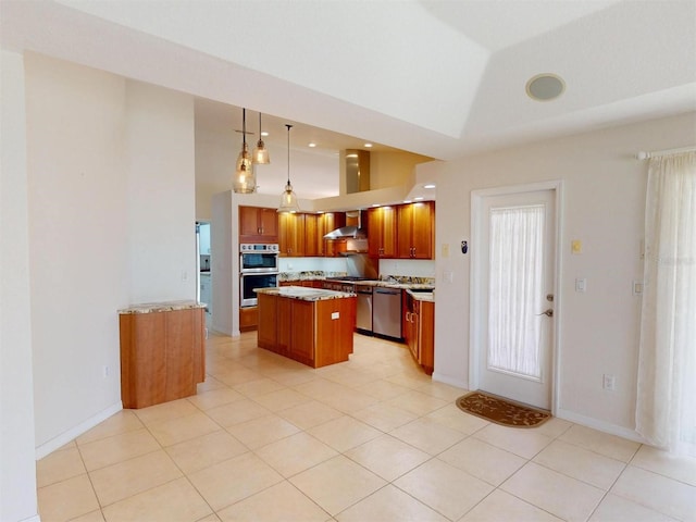 kitchen featuring brown cabinetry, appliances with stainless steel finishes, a center island, hanging light fixtures, and vaulted ceiling