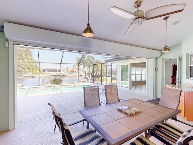 sunroom featuring ceiling fan