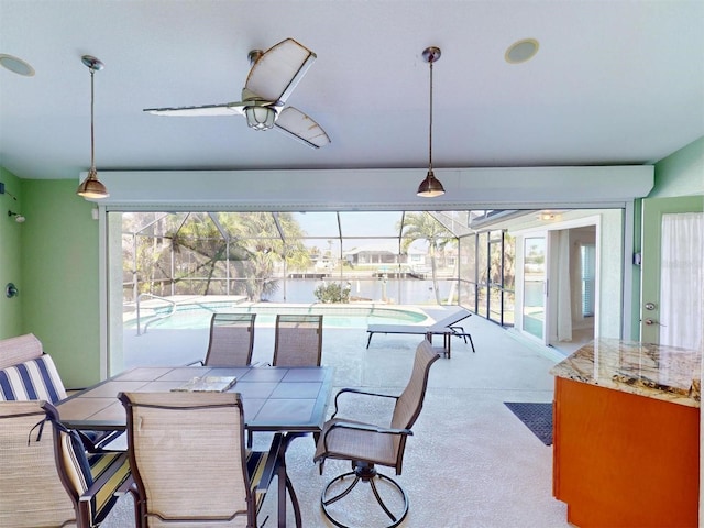 dining room with a sunroom and ceiling fan