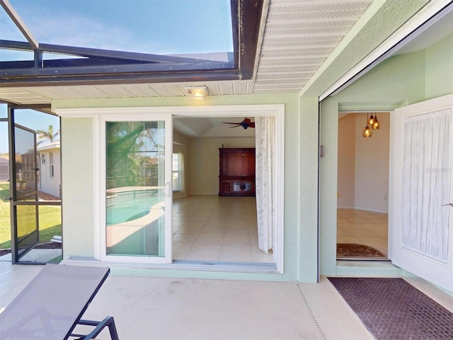 doorway to property featuring stucco siding