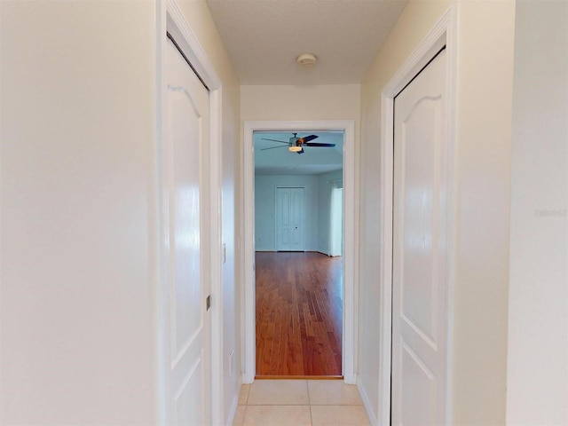 hallway featuring light tile patterned floors