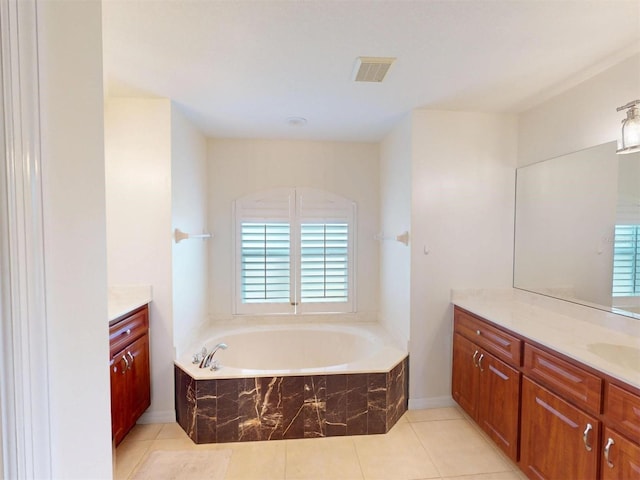 bathroom featuring a bath, tile patterned flooring, vanity, and visible vents