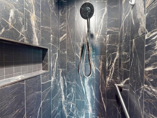 details featuring a marble finish shower