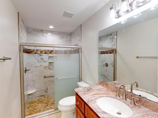 full bathroom with toilet, a stall shower, vanity, and visible vents