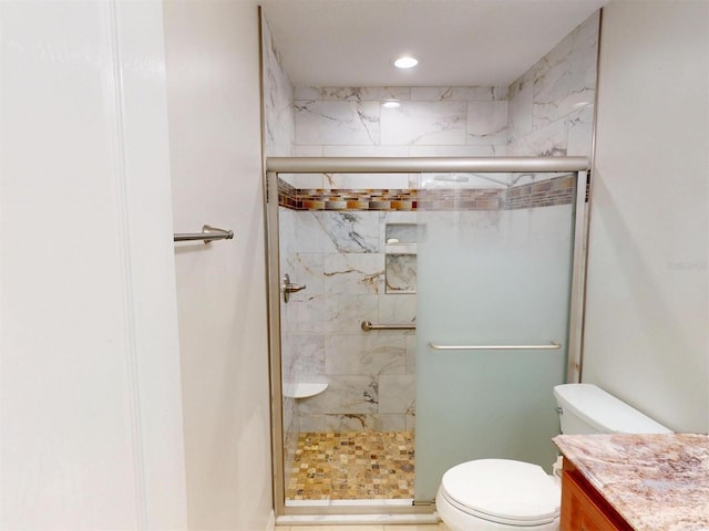 full bathroom featuring a stall shower, vanity, toilet, and recessed lighting