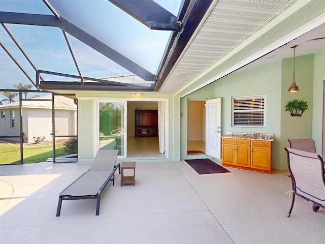 view of patio / terrace featuring glass enclosure