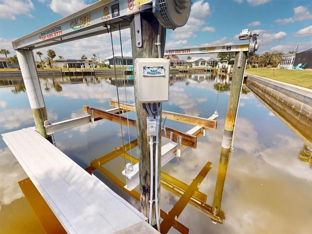 view of dock featuring a water view and boat lift