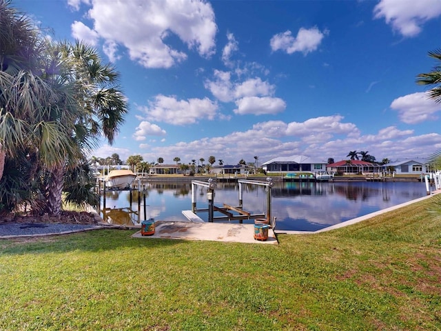 dock area featuring a lawn, a water view, and boat lift