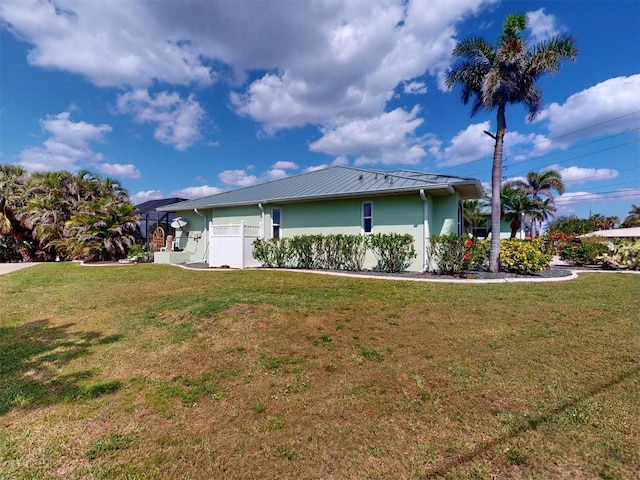 view of property exterior featuring stucco siding and a yard