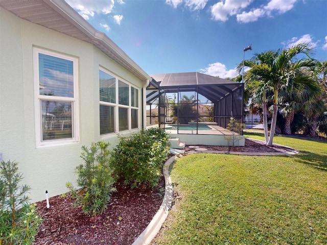 view of yard with glass enclosure and an outdoor pool