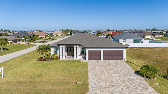 view of front of property with a garage, a front lawn, decorative driveway, and a residential view