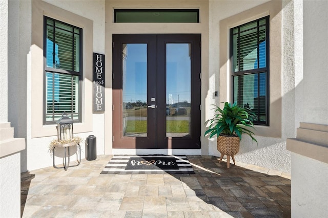 doorway to property with stucco siding and french doors