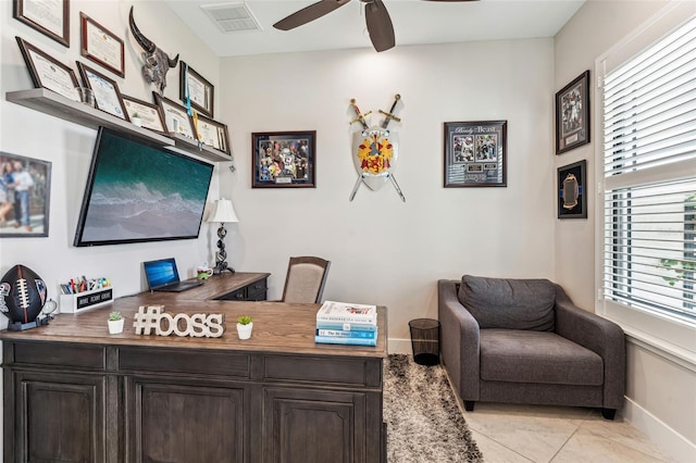 office featuring baseboards, visible vents, a ceiling fan, and light tile patterned flooring