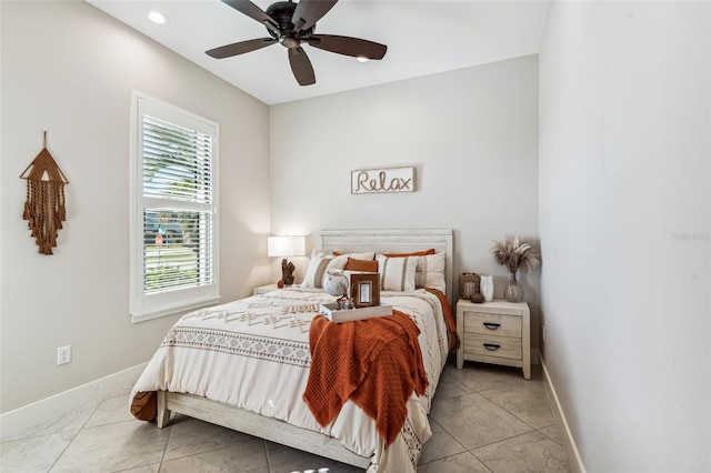 bedroom with a ceiling fan and baseboards