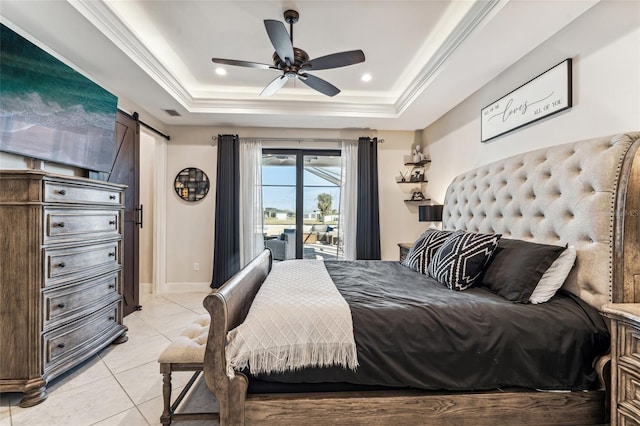 bedroom with ornamental molding, a barn door, light tile patterned floors, and a raised ceiling