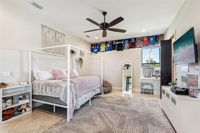 bedroom with light tile patterned floors, ceiling fan, visible vents, and baseboards