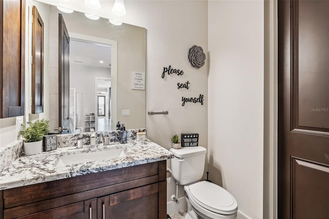 bathroom featuring toilet and vanity