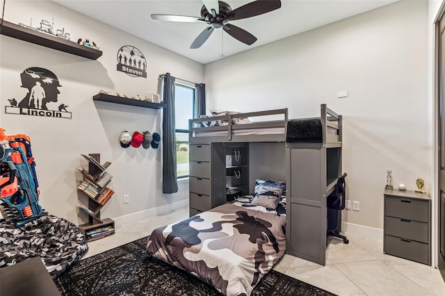 bedroom featuring light tile patterned floors, a ceiling fan, and baseboards