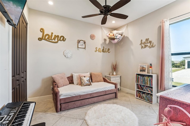 living area with recessed lighting, ceiling fan, baseboards, and light tile patterned floors