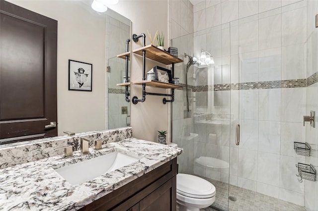 full bath featuring toilet, a shower stall, and vanity