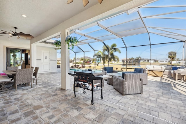 view of patio with an outdoor pool, a lanai, ceiling fan, and an outdoor living space