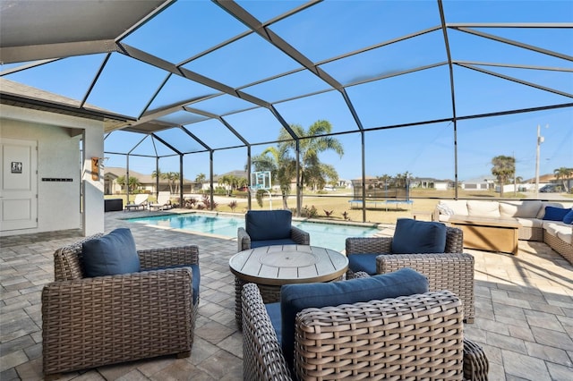 view of patio featuring glass enclosure, an outdoor pool, and an outdoor hangout area