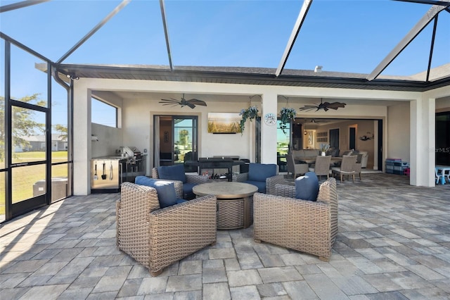 view of patio / terrace with ceiling fan, glass enclosure, outdoor dining area, and an outdoor hangout area