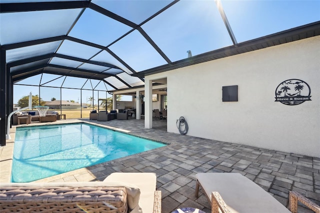 pool featuring glass enclosure, a jacuzzi, an outdoor living space, and a patio