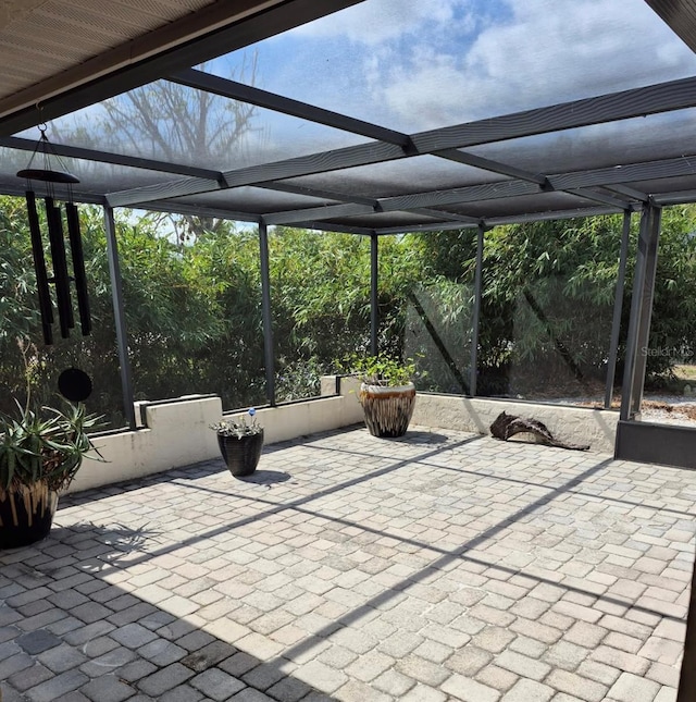 view of patio featuring a lanai