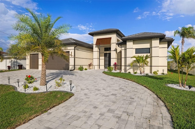 view of front facade with a front yard and a garage