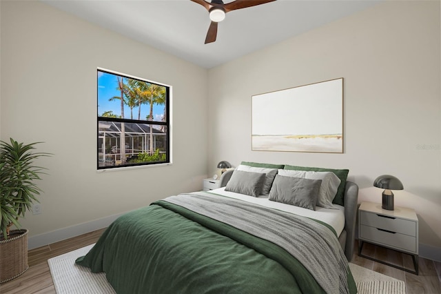 bedroom with ceiling fan and light wood-type flooring