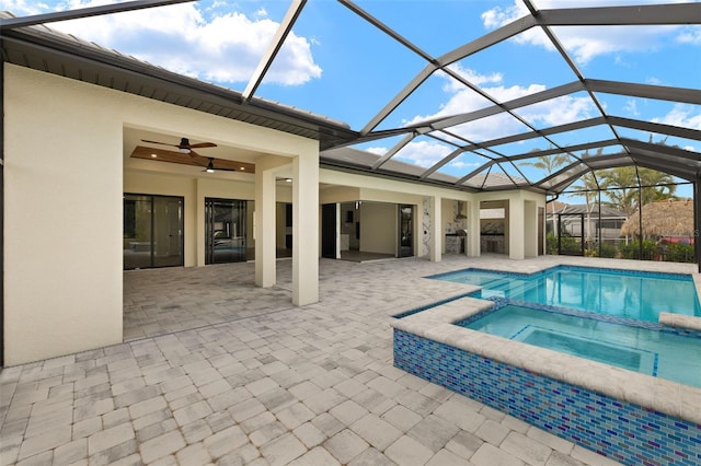 view of pool with a patio, ceiling fan, an in ground hot tub, and a lanai