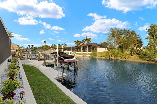 view of dock featuring a water view and a lawn