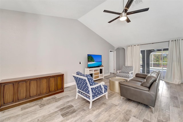 living room with ceiling fan, light hardwood / wood-style flooring, and vaulted ceiling