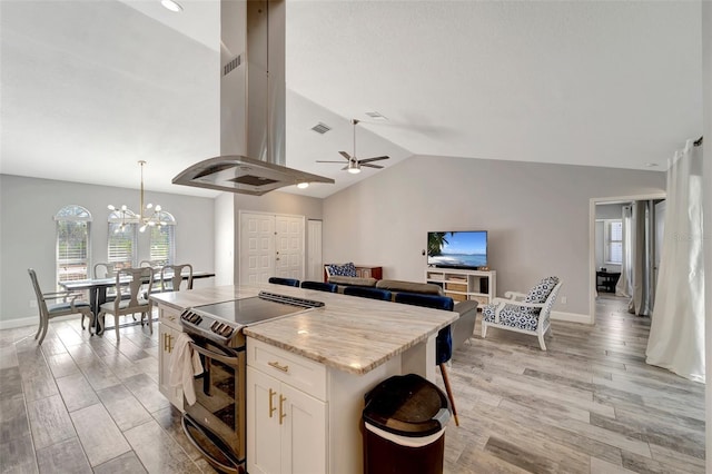 kitchen featuring white cabinetry, electric range oven, light stone countertops, island exhaust hood, and pendant lighting