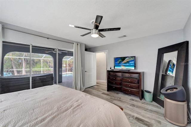 bedroom featuring access to exterior, ceiling fan, and light hardwood / wood-style flooring