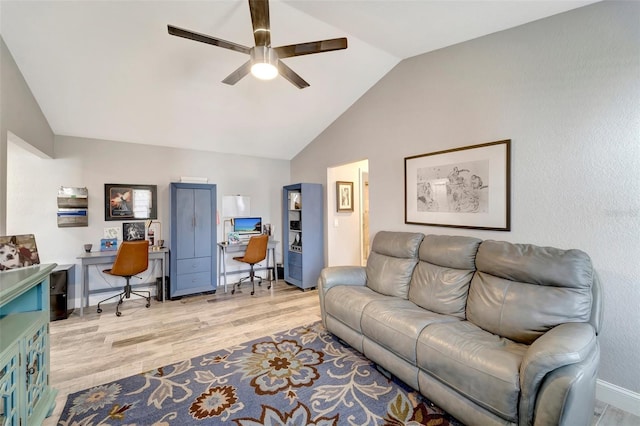 living room with ceiling fan, light wood-type flooring, and lofted ceiling