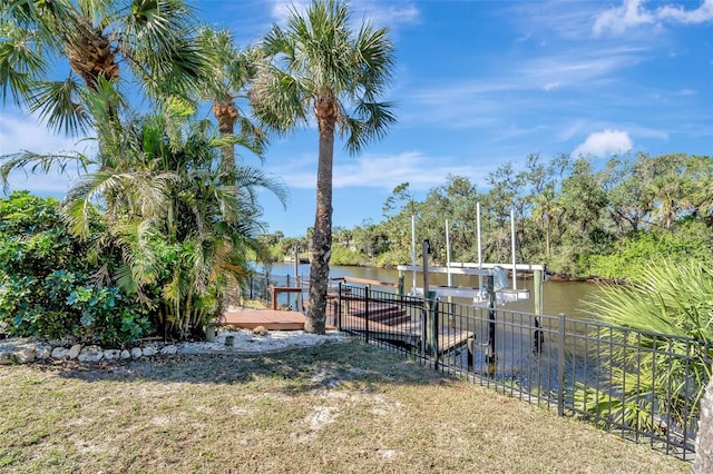 view of dock featuring a water view and a lawn