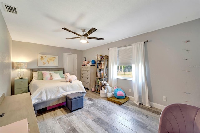 bedroom with light hardwood / wood-style flooring and ceiling fan