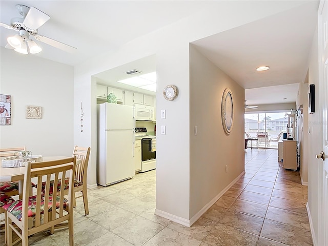 hallway with visible vents and baseboards