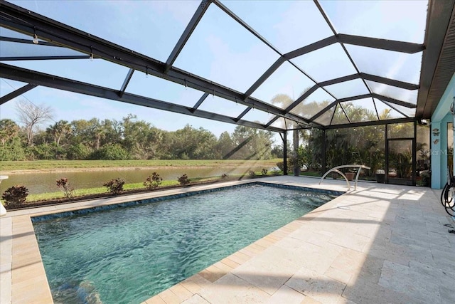 outdoor pool featuring glass enclosure and a patio area